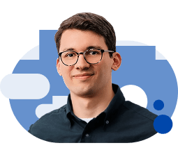 A headshot of a man smiling at the camera